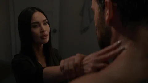 The human protagonist and the android share a tense, ambiguous moment.